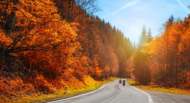 Bikers on mountainous highway, biker on the road in sunset light in autumn riding on curve road pass across Alpine mountains, extreme lifestyle, freedom concept. Austria, Alps