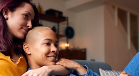 lesbian couple relaxing on a courch